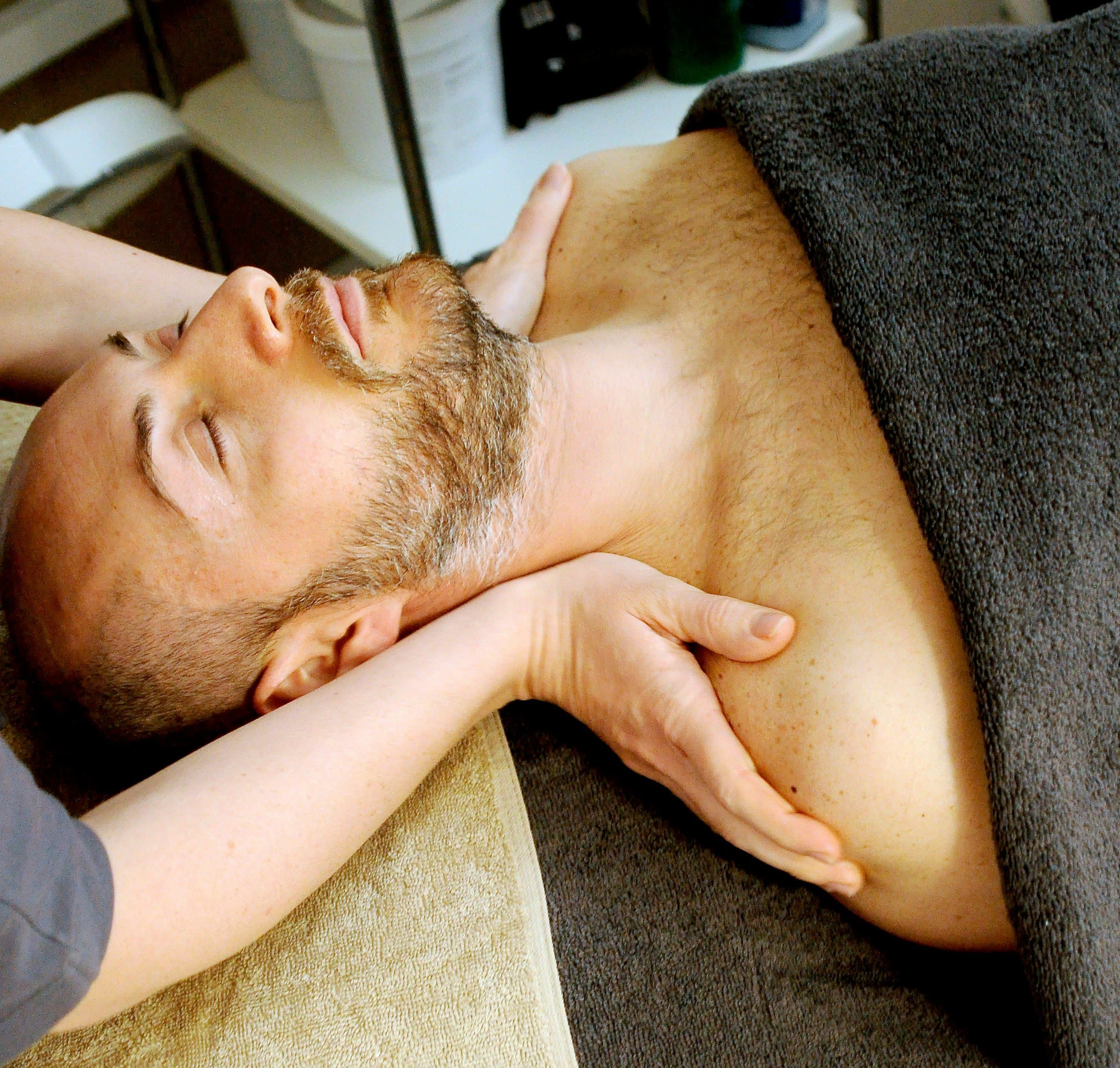 a man receiving shoulder pressure massage