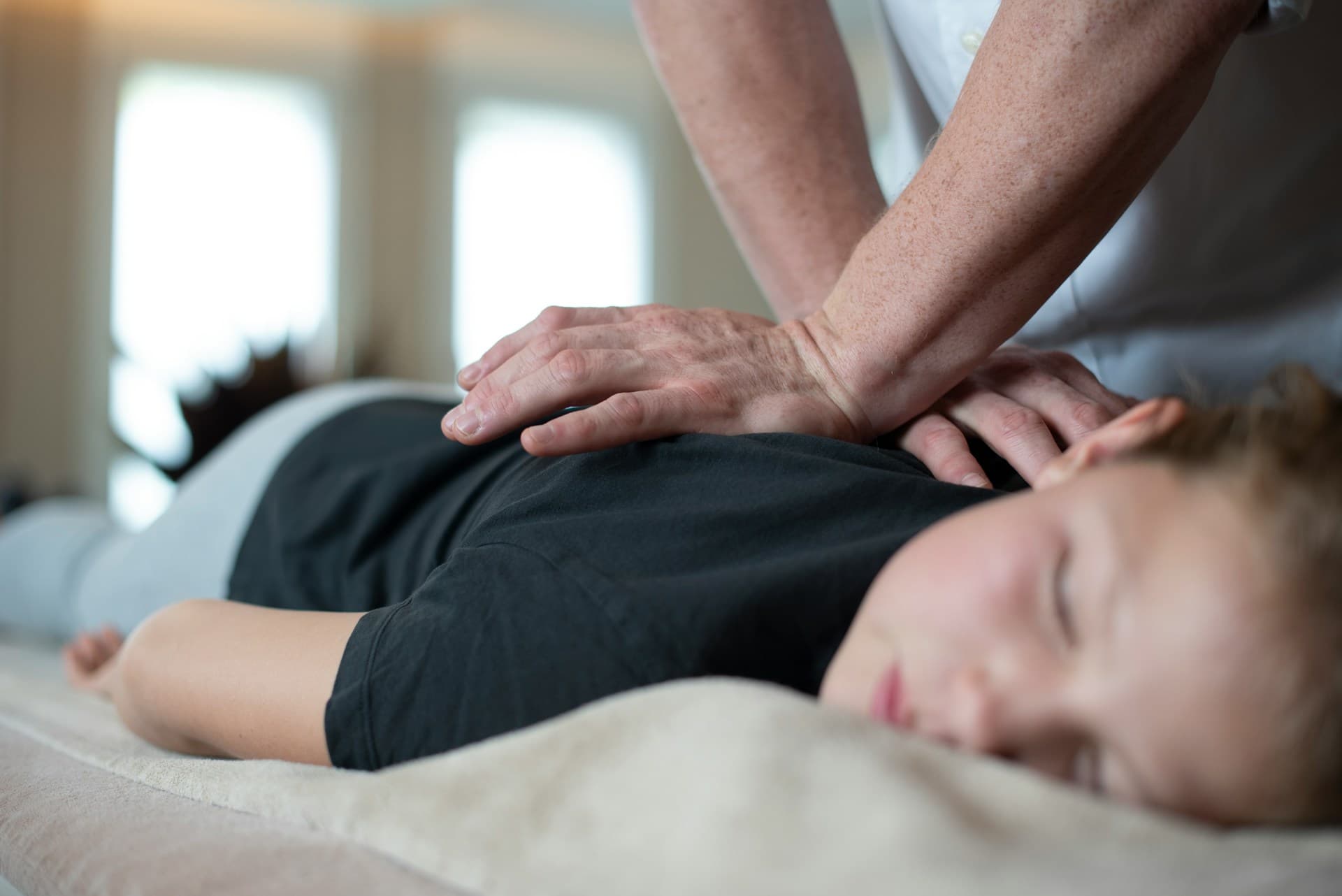 Person receiving therapeutic back massage to support pain relief and recovery
